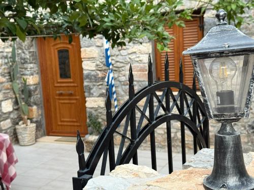 a black lantern on a fence with a door at Villa GIANNAKOS MINOAN HERSONISSOS in Kastéllion