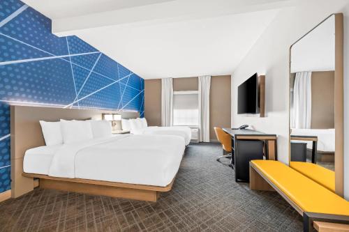 a hotel room with a bed and a desk at Comfort Inn & Suites River City Decatur in Decatur