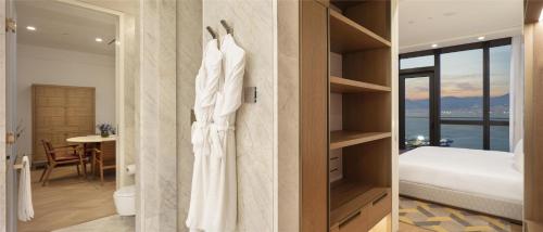 a hotel room with a bed and a bedroom with a view at Hyatt Regency Izmir IstinyePark in Izmir