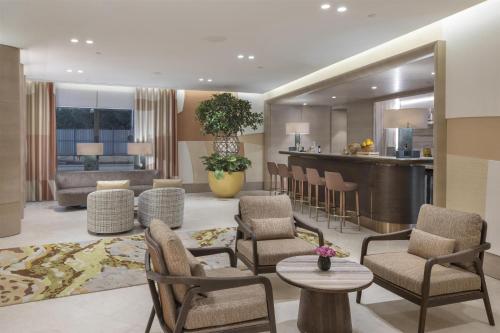 a large living room with chairs and a bar at Hyatt Regency Izmir IstinyePark in Izmir