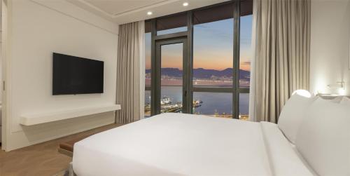 a hotel room with a bed and a large window at Hyatt Regency Izmir IstinyePark in Izmir