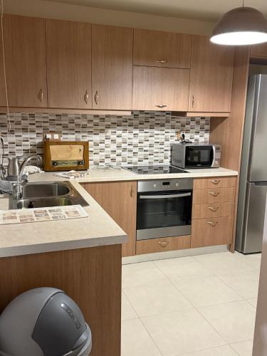 a kitchen with a sink and a stove top oven at Villa GIANNAKOS MINOAN HERSONISSOS in Kastéllion