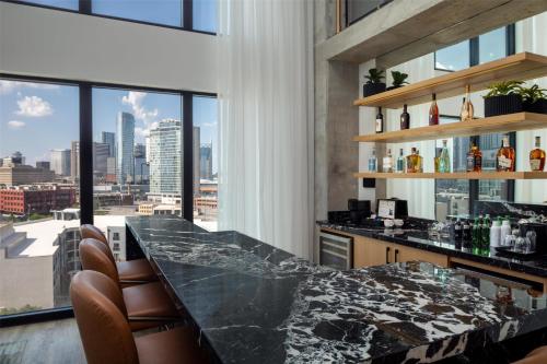 a bar with a view of the city at Canopy By Hilton Nashville Downtown The Gulch in Nashville