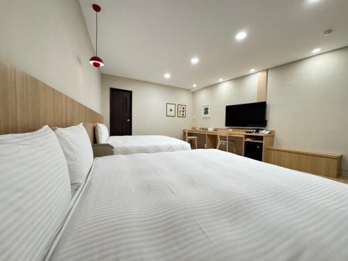 Un ou plusieurs lits dans un hébergement de l'établissement Yoshi Hotel - Tainan Sinmei Branch