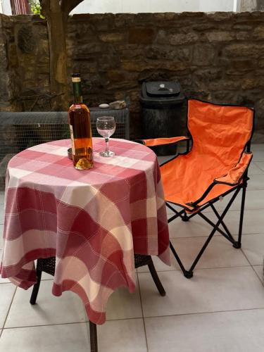 a table with a bottle of wine and a glass at Villa GIANNAKOS MINOAN HERSONISSOS in Kastéllion