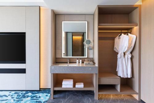 苏州苏州工业园区独墅湖戴斯温德姆酒店的浴室里有洗手池和镜子