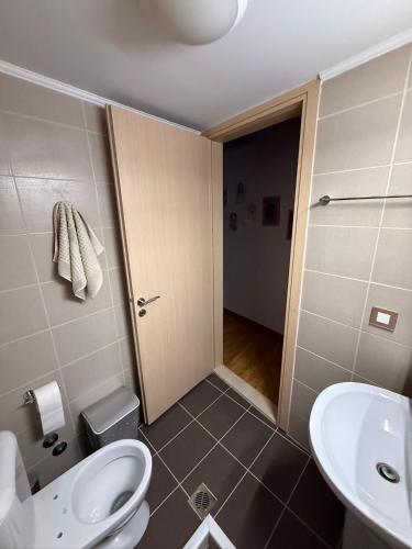 a bathroom with a toilet and a sink at Villa GIANNAKOS MINOAN HERSONISSOS in Kastéllion