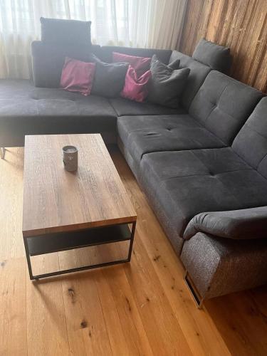 a living room with a couch and a coffee table at Premium Apartment Zentral by Alpine Host Helpers in Kirchberg in Tirol