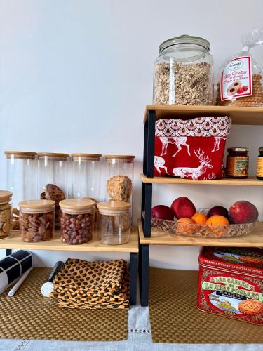 a pantry with shelves filled with different types of food at Pti Vélo in Annecy
