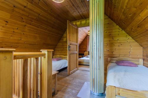 1 Schlafzimmer mit 2 Betten in einer Holzhütte in der Unterkunft Bedugnės pirtelė - Cosy Sauna House in Vilnius