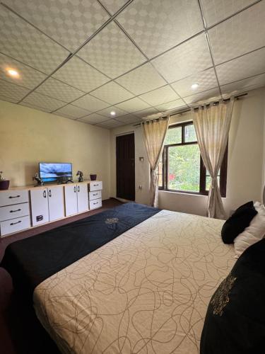 a bedroom with a large bed and a window at Northlanders Guest House Skardu in Skardu