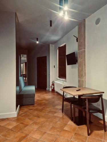a living room with a table and a chair at ArcoArilaci in Rieti