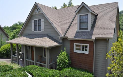 a house with a gray roof at Casa del Lago - Enjoy lake views from the decks relax on the screened-in deck in Marblehill