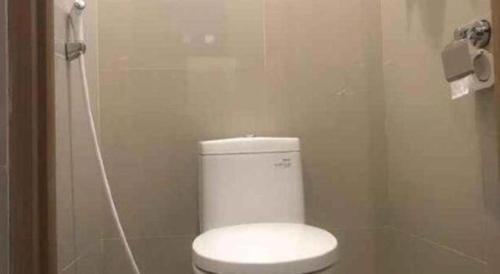 a bathroom with a white toilet and a shower at InnBox Capsule Hotel in Jember