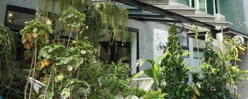 a building with plants on the side of it at NiHao Café Hotel in Taipei