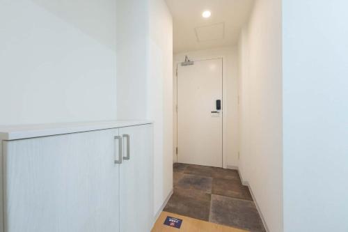 a hallway with a white cabinet and a door at Fujiterrace Yoga in Tokyo
