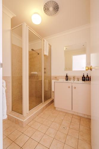 a bathroom with a shower and a sink at The Oceanside Stay by the BnB Collection in Albany