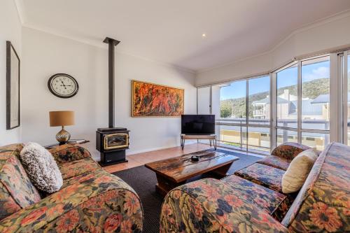 a living room with two couches and a tv at The Oceanside Stay by the BnB Collection in Albany