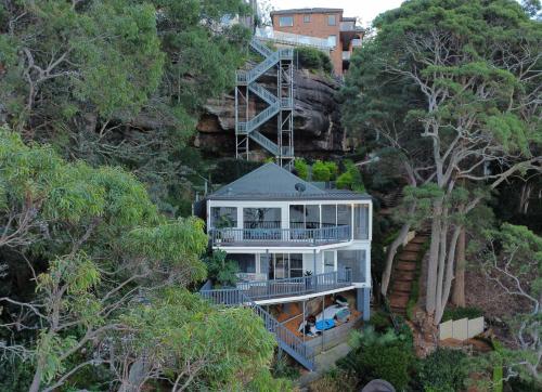 a house on the side of a mountain at Breathtaking Waterfront Retreat- Studio Apartment