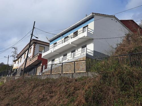 a white house on top of a hill at Asturias Montaña y Playa in La Vega