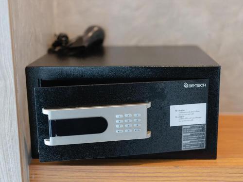a black microwave oven sitting on top of a table at B2 Krabi Premier Hotel in Ao Nang Beach