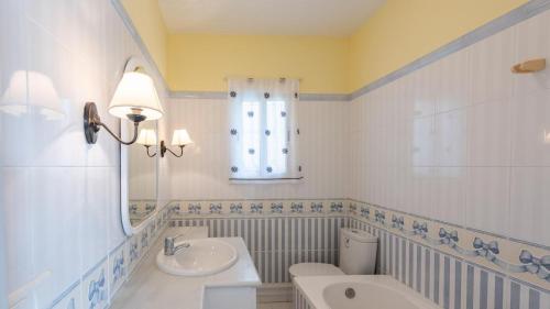 a bathroom with a sink and a toilet and a mirror at Villa en Lagos Bajo Vélez-Málaga by Ruralidays in Vélez-Málaga