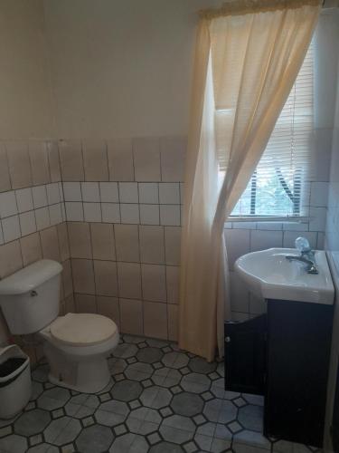 a bathroom with a toilet and a sink at Apartments 145 in Georgetown