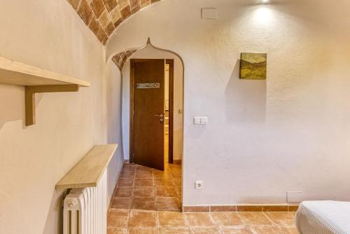 a hallway with a door in a building at Mas la Ginesta in Borrassá