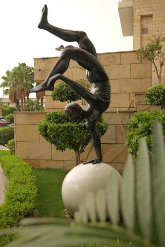 a statue of a person doing a trick on a ball at Holiday Inn New Delhi Mayur Vihar Noida by IHG in New Delhi