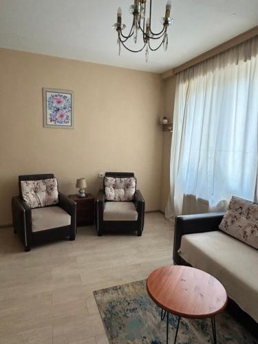 a living room with two chairs and a couch at Apartment near Tskaltubo spa restort in Tskaltubo