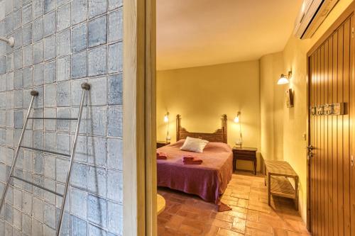 a bedroom with a bed and a walk in shower at Mas la Ginesta in Borrassá
