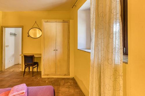 a living room with yellow walls and a door at Mas la Ginesta in Borrassá