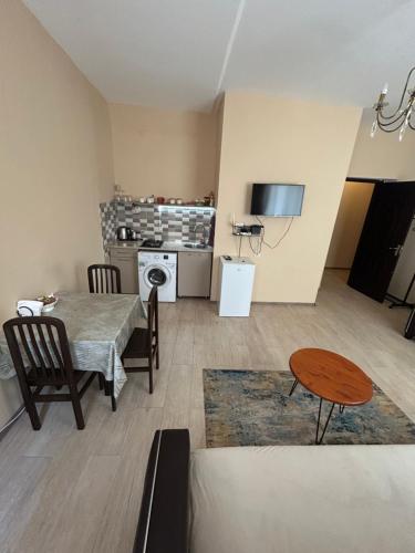 a living room with a table and a dining room at Apartment near Tskaltubo spa restort in Tskaltubo