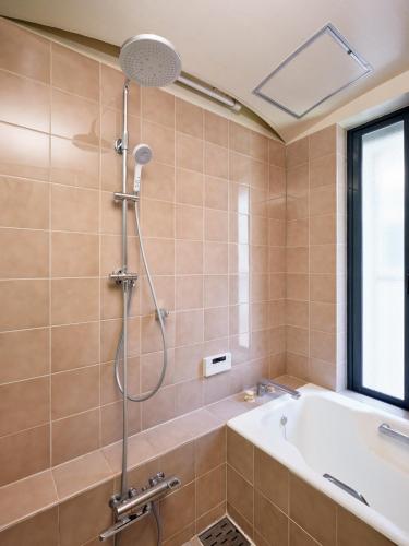 a bathroom with a shower and a bath tub at Noël Shibuya Once -Luxury Residence in Tokyo