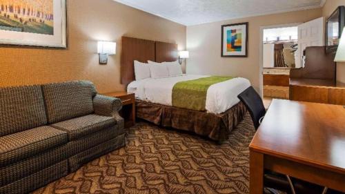 a hotel room with a bed and a couch at Best Western Athens in Athens