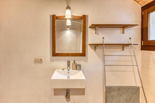 a bathroom with a sink and a mirror at Mas la Ginesta in Borrassá