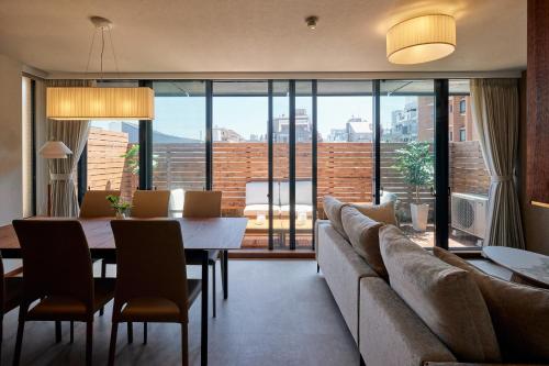 a living room with a couch and a table at Noël Shibuya Once -Luxury Residence in Tokyo