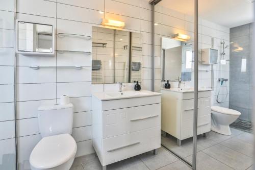 a bathroom with a toilet and a sink and a mirror at La tranquilité bleue - Maison avec Parking cloturé in Les Sables-dʼOlonne