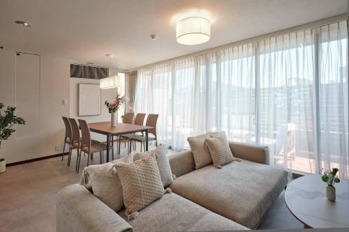 a living room with a couch and a table at Noël Shibuya Once -Luxury Residence in Tokyo
