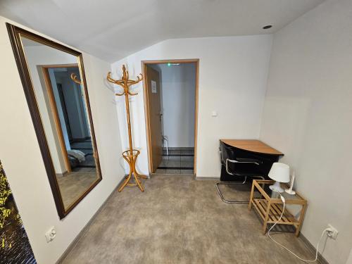 a room with a mirror and a table and a desk at Roller Hostel in Łódź