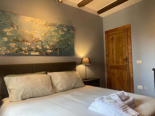 a bedroom with a bed with a painting on the wall at Colonna House in Genazzano