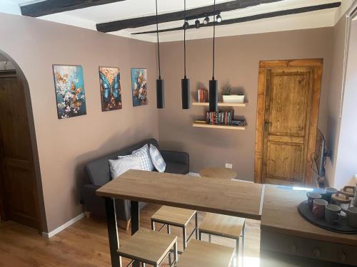 a dining room with a table and a couch at Colonna House in Genazzano