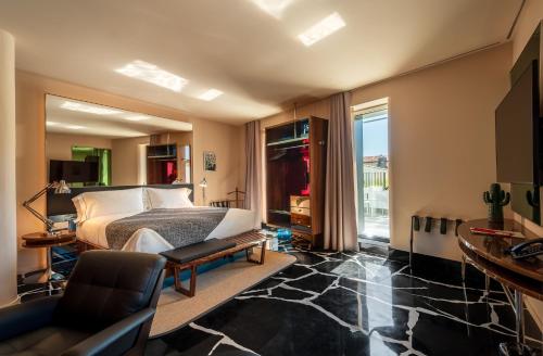 a bedroom with a bed and a large window at Hotel Calimala Milano in Milan