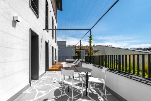 a balcony with a table and chairs on a building at Hotel Calimala Milano in Milan