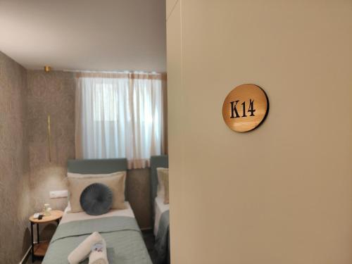 a bedroom with a bed and a clock on the wall at CORFU TENNIS Studios in Agios Rokkos