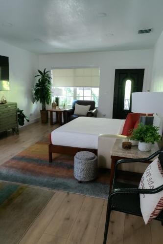 a living room with a white bed and a couch at Spacious Family 3BR Near Wynwood and Beach in Miami