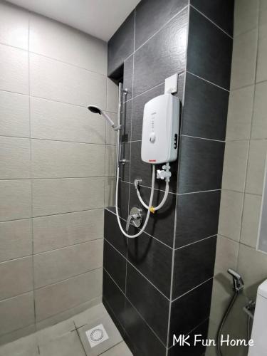 a bathroom with a soap dispenser on a tiled wall at Apartment in Kajang WIFI Smart TV in Kajang