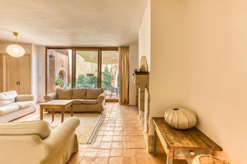 a living room with a couch and a table at Mas la Ginesta in Borrassá