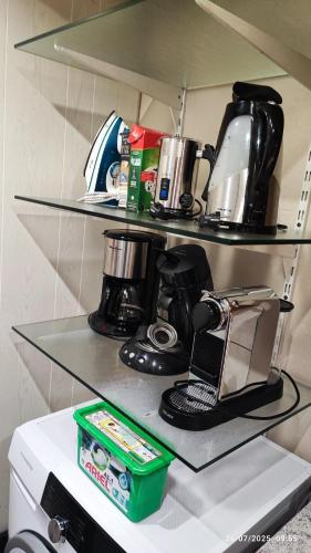a shelf with a coffee maker on top of a refrigerator at Gîte Oncle Yerry Ostheim in Ostheim