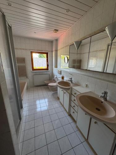 a bathroom with two sinks and two toilets at Ferienwohnung Nagel in Gersheim